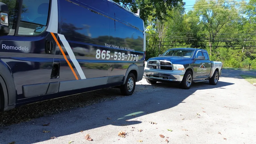 Everything Handyman branded van and blue pickup parked outside in daylight