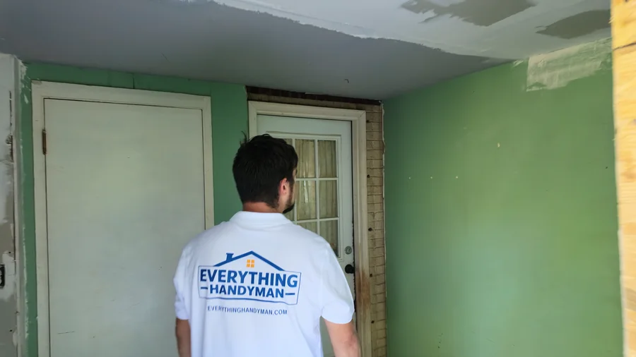 Everything Handyman crew member inside a room with exposed drywall seams and a prepared doorway