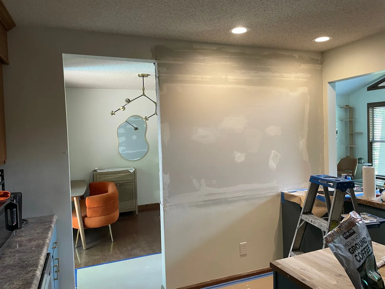 Room walls with visible drywall patches and joint compound