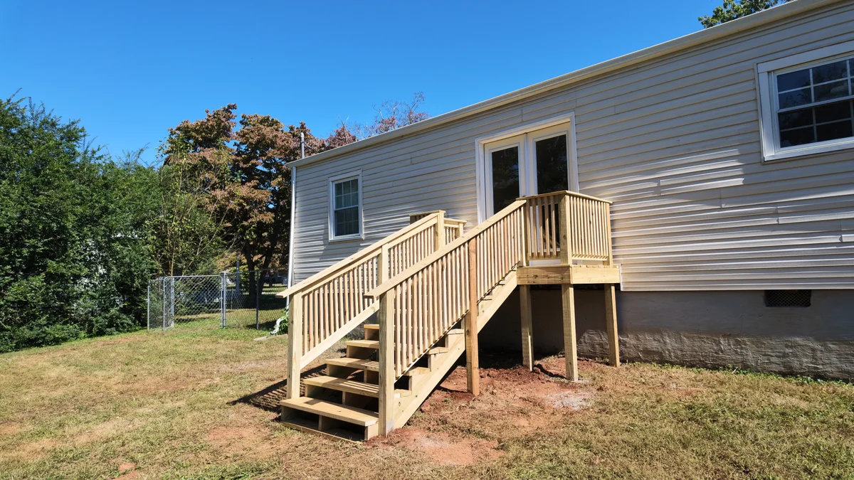 Timber exterior steps and railings leading to double patio doors