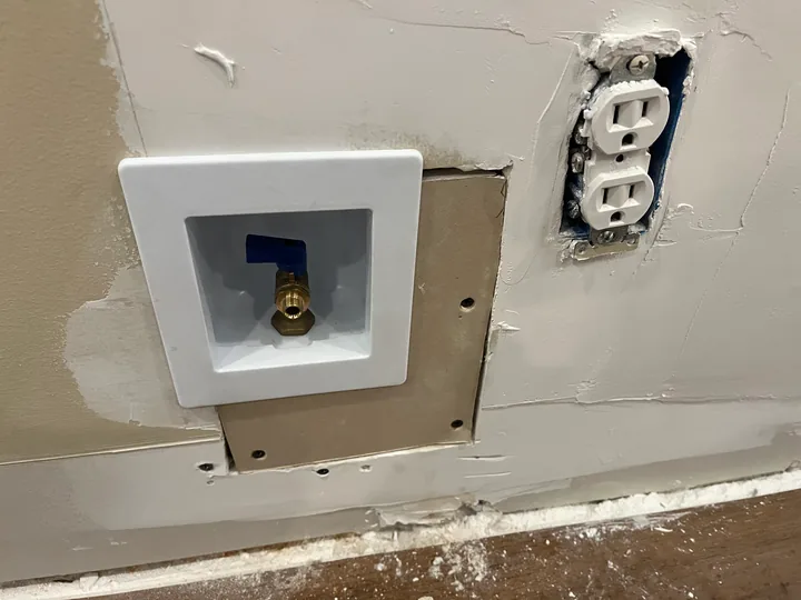 Laundry hookup box and accessible supply-line work inside an open wall