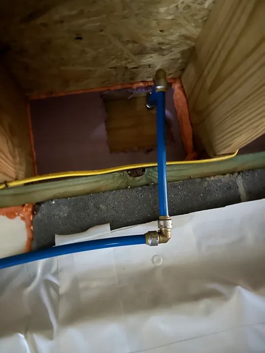 Laundry hookup box and accessible supply-line work inside an open wall