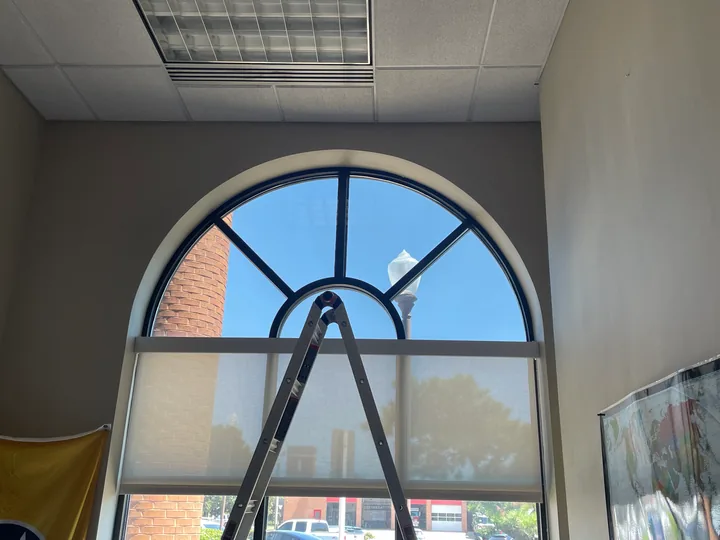 Large arched window and nearby skylight in an interior room