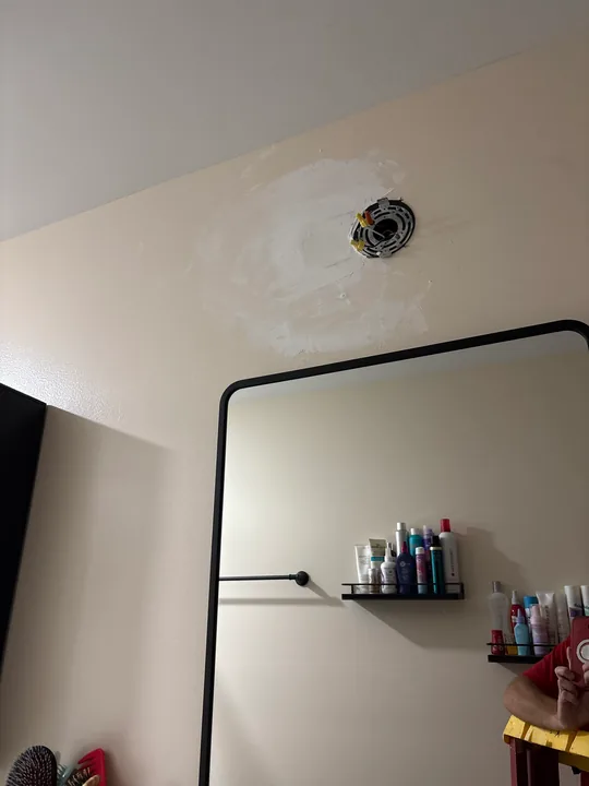 White bathroom basin, dark faucet and framed mirror