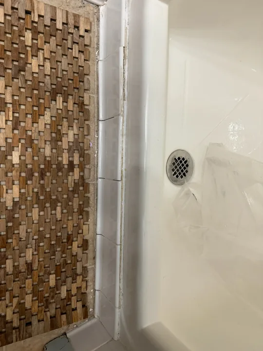 Bathroom wall preparation and drywall patches near tile