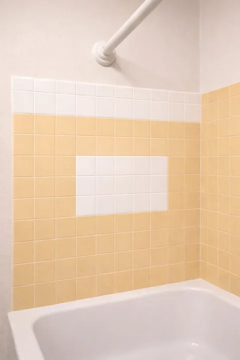 Bathroom wall preparation and drywall patches near tile
