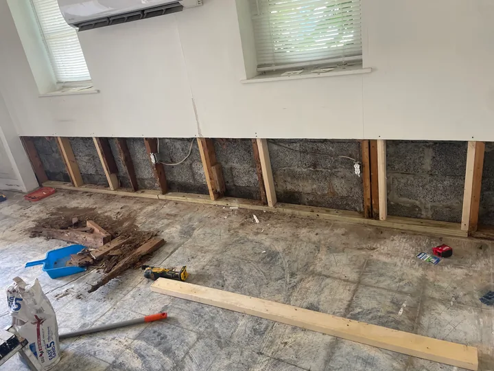 Wood-look plank flooring beside a toilet and white bathroom vanity