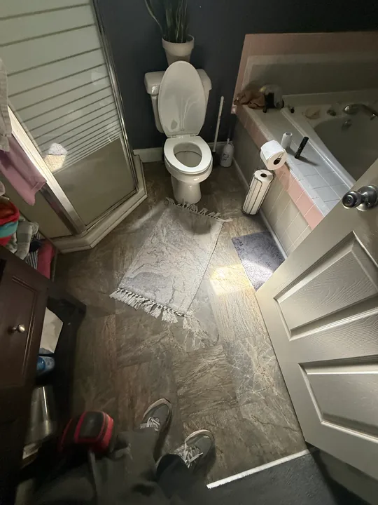 Bathroom flooring preparation around a tub, toilet and vanity