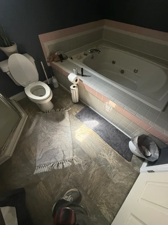 Bathroom flooring preparation around a tub, toilet and vanity