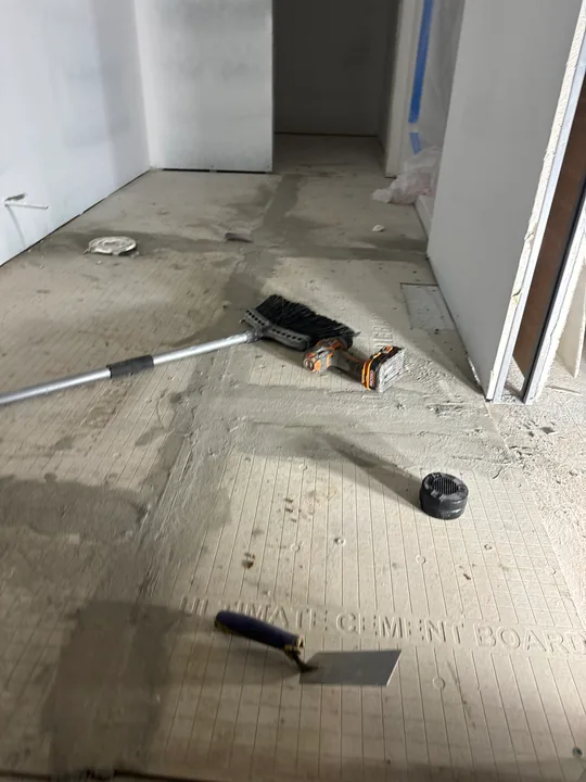 Bathroom floor preparation and opening around a fixture connection
