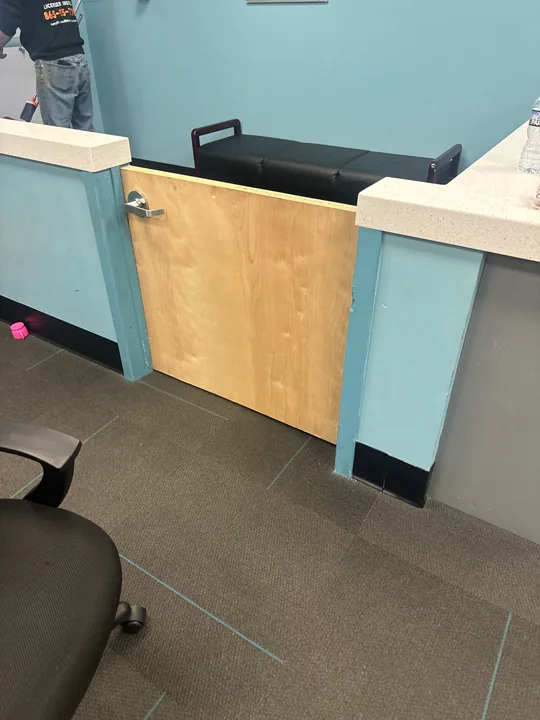 Blue kitchen cabinets with wood countertop and a tiled backsplash