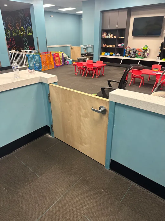 Blue kitchen cabinets with wood countertop and a tiled backsplash