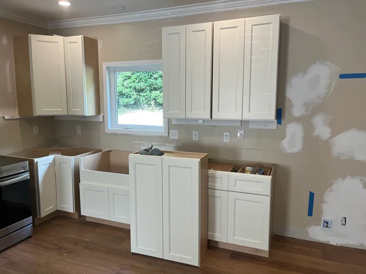White kitchen cabinets and drawer boxes during installation