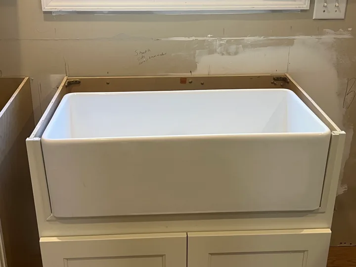 White kitchen cabinets and drawer boxes during installation