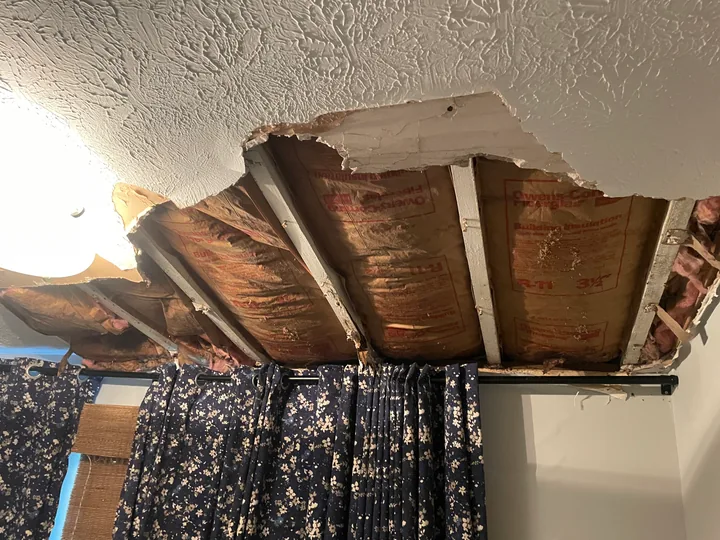 Damaged ceiling opening, exposed framing and existing textured finish
