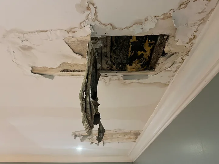 Damaged ceiling opening, exposed framing and existing textured finish