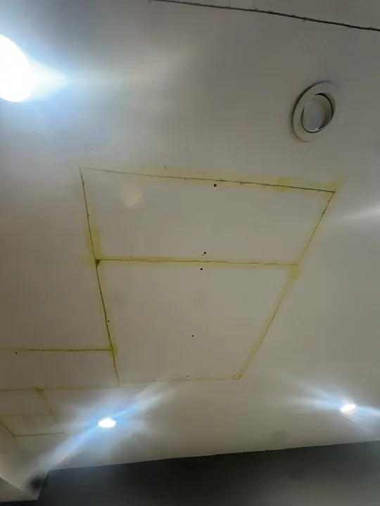 Ceiling drywall panels, taped joints and recessed lights