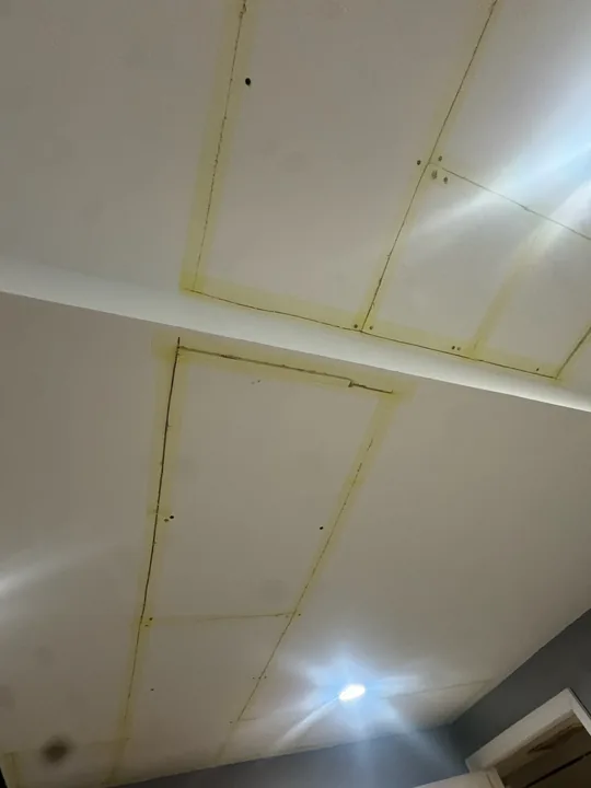 Ceiling drywall panels, taped joints and recessed lights