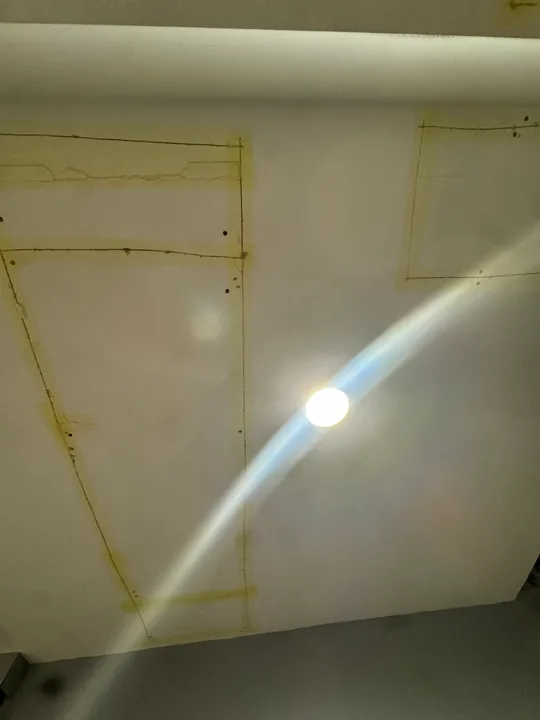 Ceiling drywall panels, taped joints and recessed lights