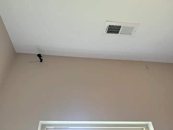 Light painted ceiling, ventilation grille and window trim