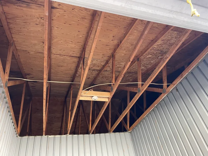 Exposed ceiling framing, support mesh and partial drywall panels