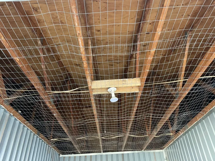 Exposed ceiling framing, support mesh and partial drywall panels