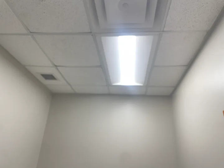 Suspended ceiling panels, rectangular lights and ventilation grille