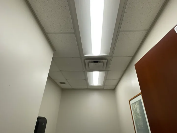 Suspended ceiling panels, rectangular lights and ventilation grille