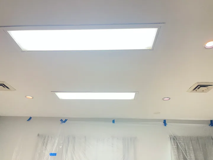 Room windows, ceiling lights and surfaces being prepared for finishing