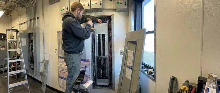 Technician working on a commercial door and frame