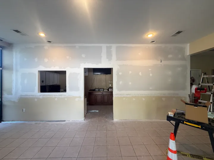 Joint compound on commercial partition walls beside two doorways