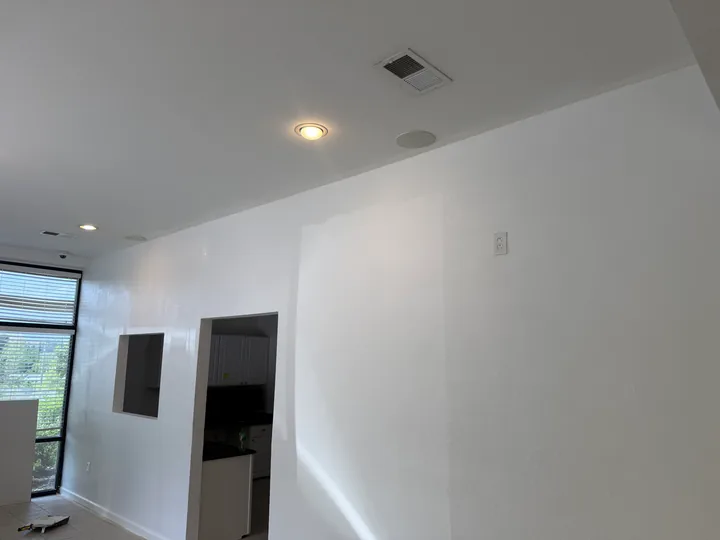 Painted commercial interior walls beside existing cabinetry and a tiled floor
