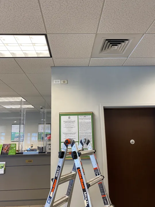 Commercial interior with painted blue walls and a step ladder