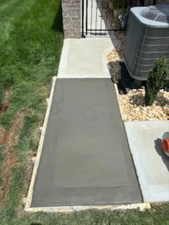 Exterior concrete and masonry steps beside a brick entrance