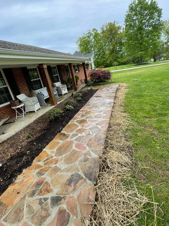Paver courtyard, stone wall and timber outdoor structure