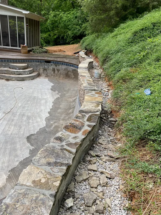 Curved paver border and low masonry retaining wall