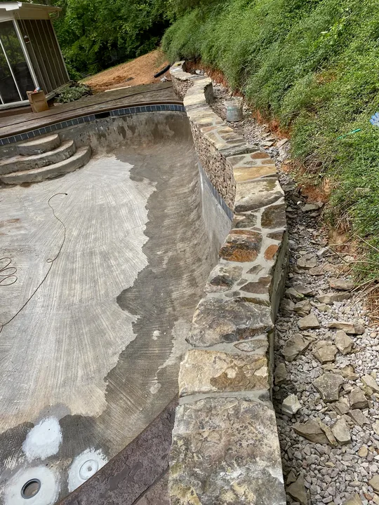 Curved paver border and low masonry retaining wall