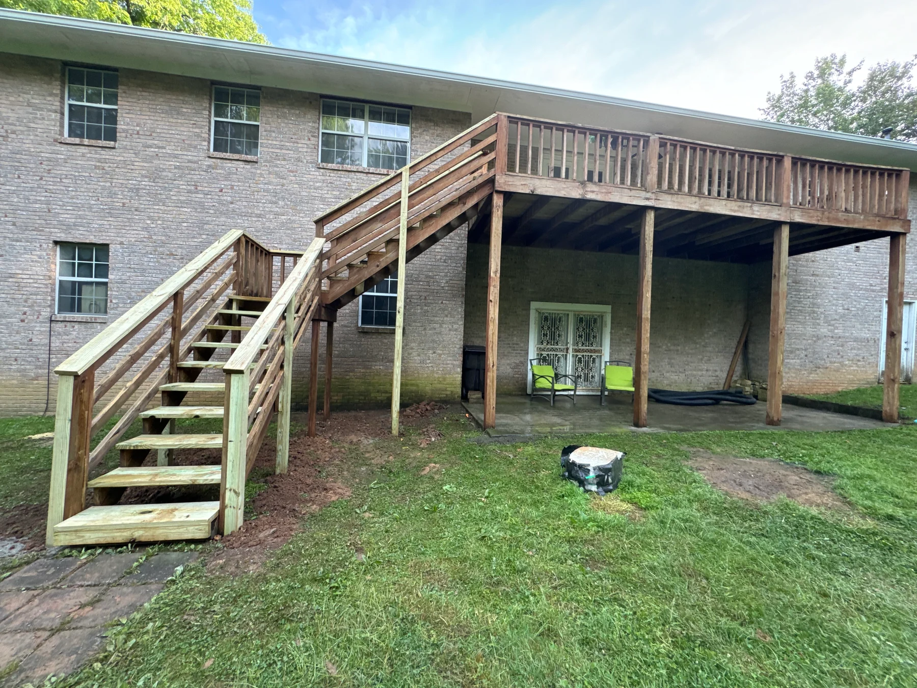 Exterior deck with weathered boards, timber stairs and railing