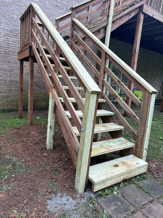 Exterior deck with weathered boards, timber stairs and railing