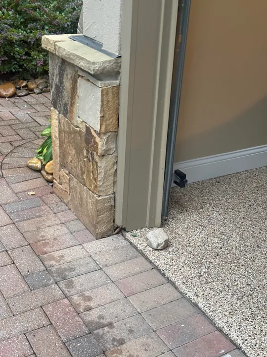 White entry door, threshold and stone exterior wall
