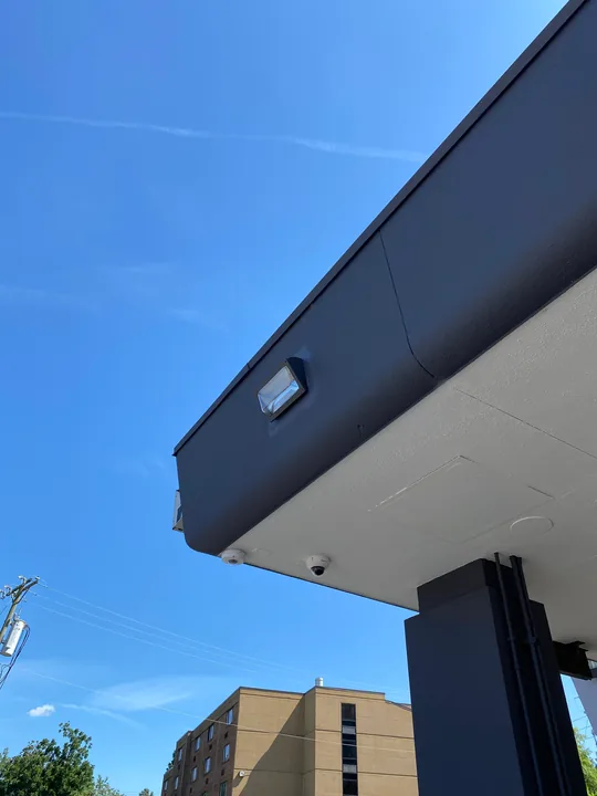 Square exterior wall light beside a soffit