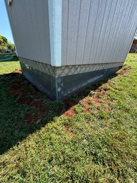 White exterior skirting and lattice beneath siding