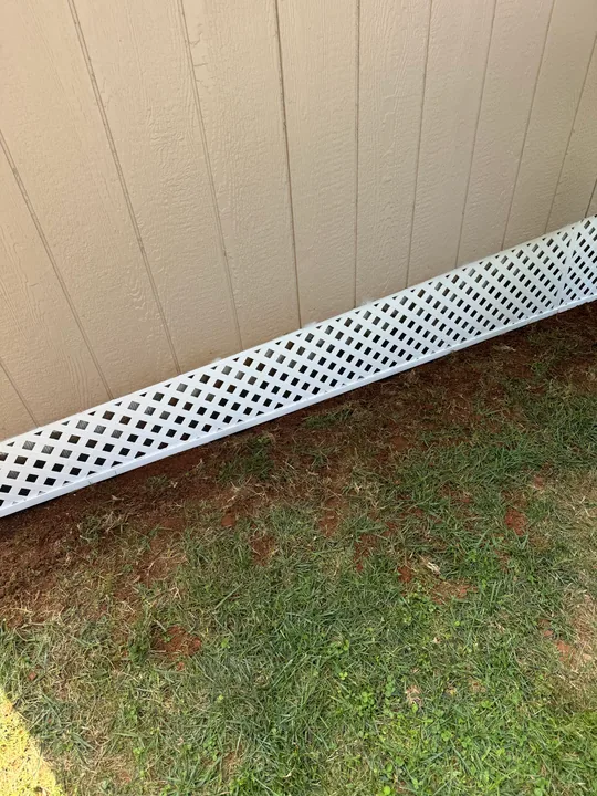 White exterior skirting and lattice beneath siding
