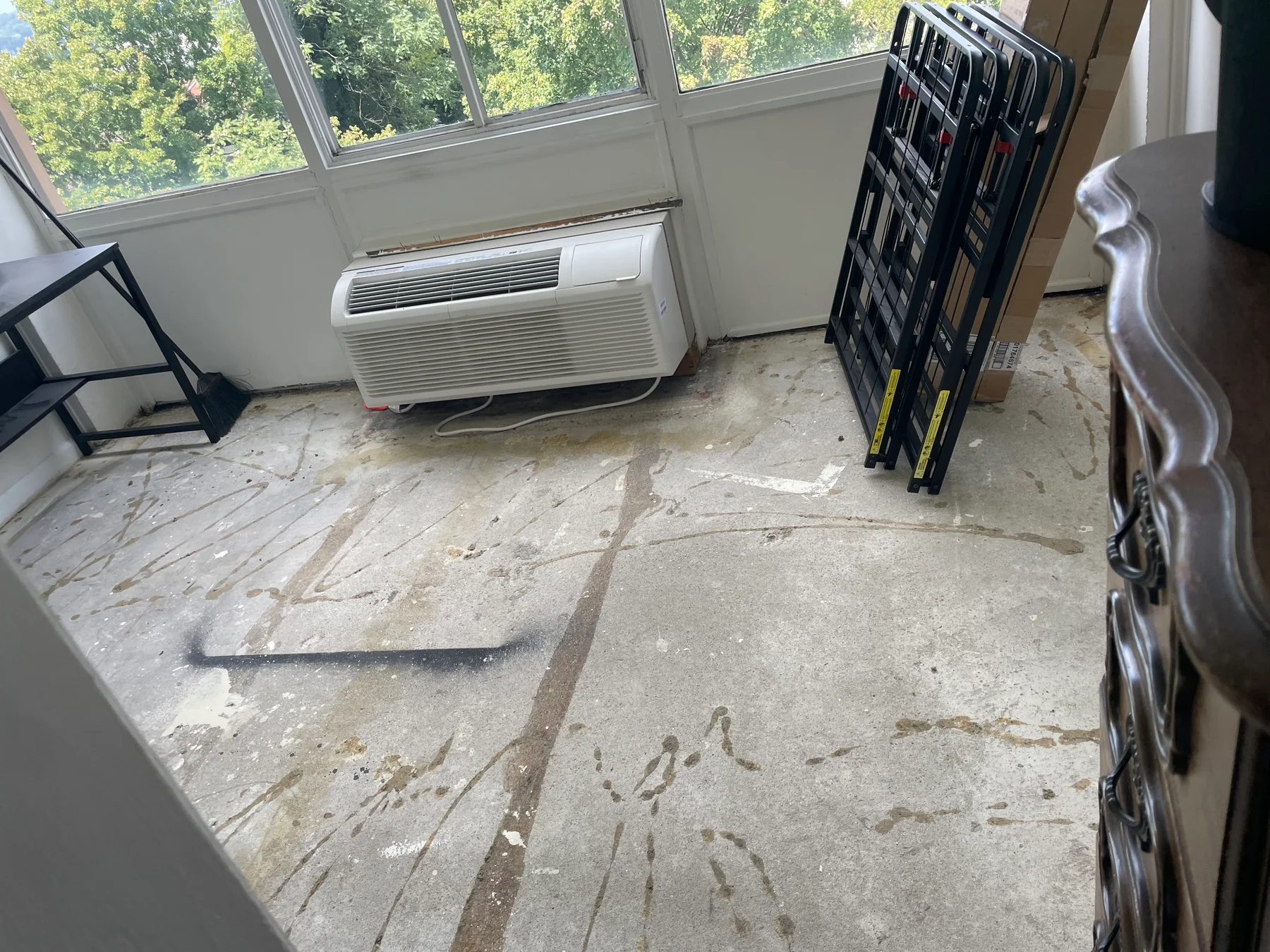 Room floor with old covering removed and surface preparation visible