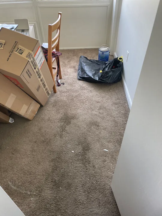 Room floor with old covering removed and surface preparation visible