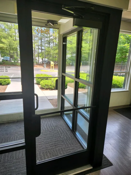 Dark-framed glass commercial entrance and door hardware
