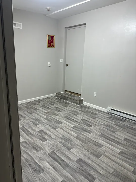 Gray plank flooring, subfloor preparation and light room walls