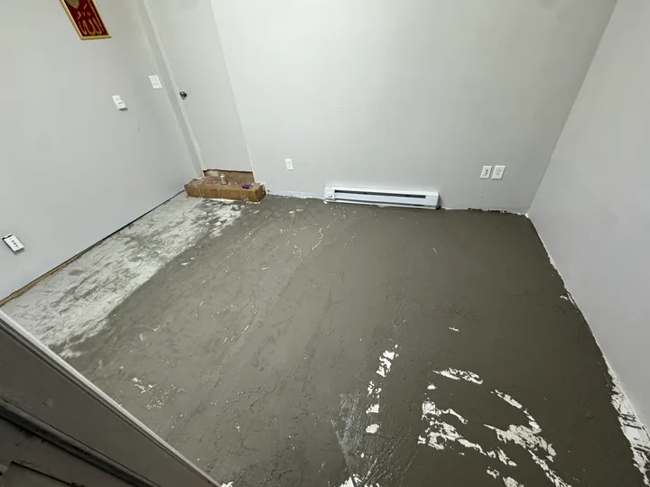 Gray plank flooring, subfloor preparation and light room walls