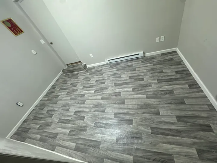 Gray plank flooring, subfloor preparation and light room walls