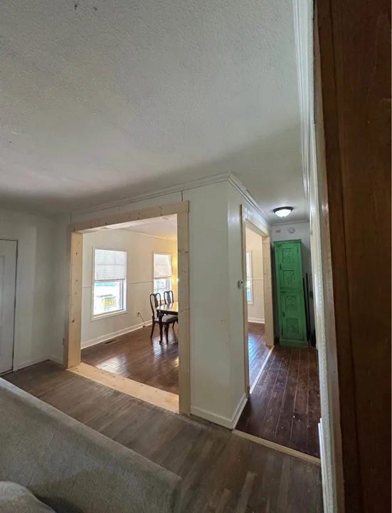 Wood flooring through a light interior and doorways